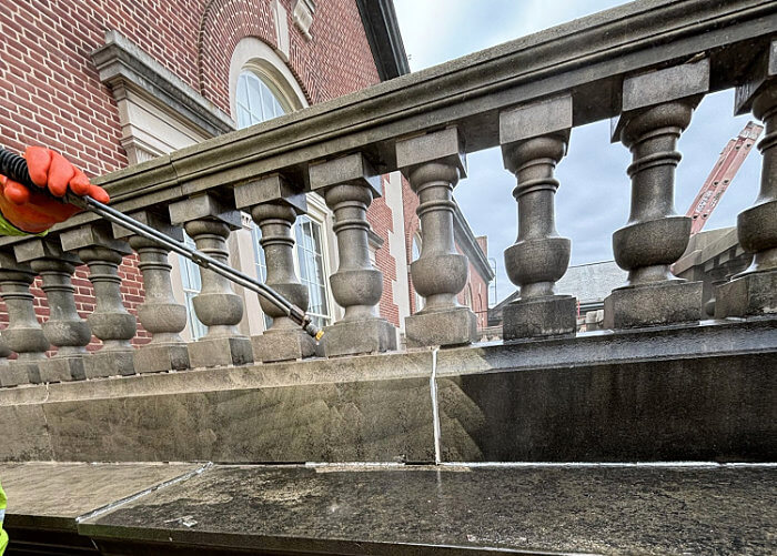 Powerwashing a historic structure in Shannon's North Portico Restoration of the National Emergency Training Center