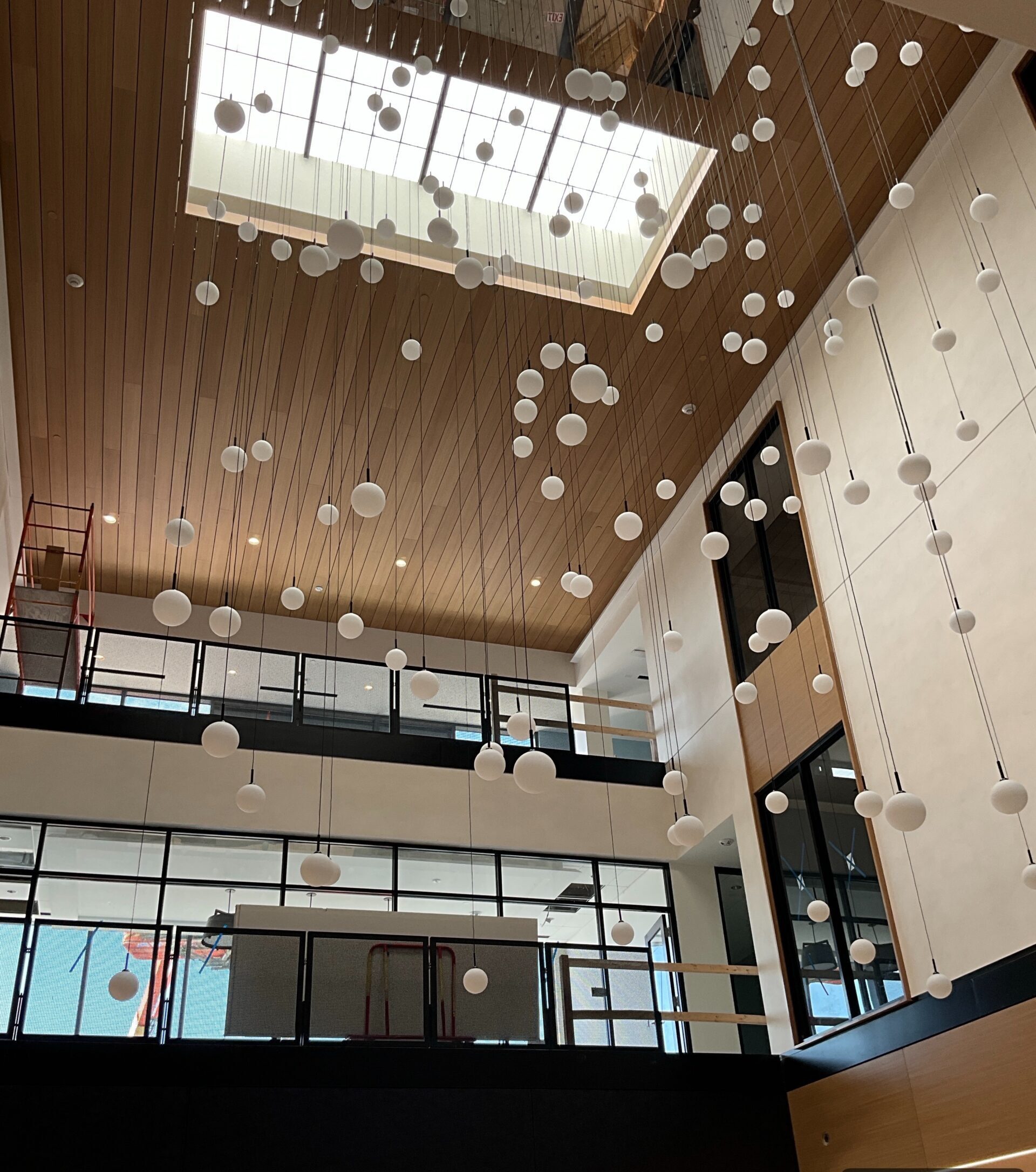 The new three-story atrium at Commonwealth Charter Academy’s Moosic campus features a skylight and suspended lighting installation, transforming the building’s center into an open, light-filled space.